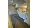 Open-concept living room featuring new floors and neutral paint at 5578 Metrowest Blvd # 305, Orlando, FL 32811