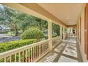 Inviting front porch with white railings and columns offering shade and curb appeal at 6613 Duncaster St, Windermere, FL 34786