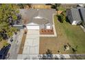 Aerial view of single Gathering home featuring a spacious driveway, landscaping and a fenced backyard at 823 Kokomo Cir, Port Orange, FL 32127