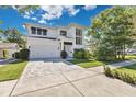 Beautiful two-story modern home with a two-car garage, gorgeous landscaping, and a long walkway to the front door at 1312 Vassar St, Orlando, FL 32804