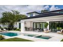 Outdoor space featuring a luxurious pool, hot tub, covered dining area, and a built-in outdoor kitchen, perfect for entertaining at 1402 Stetson St, Orlando, FL 32804