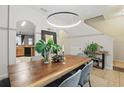Bright dining area features wood table, modern light fixture, and stylish decor at 14467 Prunningwood Pl, Winter Garden, FL 34787