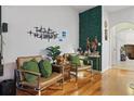 Living room showcases two leather chairs, stylish decor, and a unique vertical green wall at 14467 Prunningwood Pl, Winter Garden, FL 34787