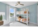 A cozy bedroom with a bunk bed, bright decor, and a window offering natural light at 15343 Rising View Dr, Montverde, FL 34756