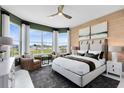 A spacious and well-lit main bedroom featuring a large window and a comfortable seating area at 15343 Rising View Dr, Montverde, FL 34756
