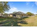 Large grassy backyard with a storage shed provides ample space for outdoor activities at 2011 Oakbend Dr, Eustis, FL 32726