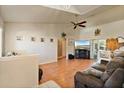 Open-concept living room with vaulted ceilings, wood floors, and sliding glass doors for natural light at 2011 Oakbend Dr, Eustis, FL 32726