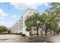 Attractive multi-story condo building with white and gray facade near a well-maintained street at 202 E South St # 5046, Orlando, FL 32801