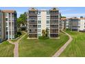 Well-maintained condo building featuring screened patios and lush green landscaping at 204 Quayside Cir # 501, Maitland, FL 32751