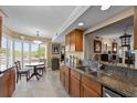Well-lit kitchen features granite counters, stainless appliances and cozy breakfast nook at 204 Quayside Cir # 501, Maitland, FL 32751