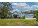 Charming two-story home showcasing a manicured lawn and a spacious three-car garage at 2240 W Dale Cir, Deland, FL 32720