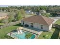 Aerial view of the backyard featuring a private pool, patio area, and lush greenery at 2662 Haulover Blvd, Deltona, FL 32738