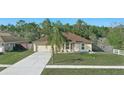 Single-story home with a well-manicured front yard and a paved driveway leading to the garage at 2662 Haulover Blvd, Deltona, FL 32738