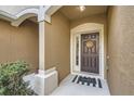 Covered front porch with a decorative wreath and a 'hello' welcome mat at 2804 Polvadero Ln # 107, Orlando, FL 32835
