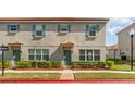 Well-maintained townhome featuring updated windows, manicured shrubs, and a vibrant front exterior at 3127 Via Otero Dr, Kissimmee, FL 34744