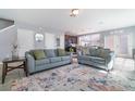 Comfortable living room featuring plush sofas, an area rug, and an open layout connected to the kitchen at 3127 Via Otero Dr, Kissimmee, FL 34744