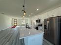 Spacious kitchen features quartz countertops, a large island with seating and stainless steel appliances at 489 Marion Oaks Golf Rd, Ocala, FL 34473