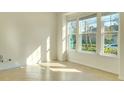 Sunlit bedroom featuring tile flooring, large windows, and bright neutral walls at 5029 Southlawn Ave, Orlando, FL 32811