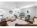 Cozy living room featuring neutral decor, a ceiling fan, television, and hardwood floors at 515 Clayton St, Orlando, FL 32804
