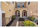 Inviting front courtyard with wrought iron gate and dual entrances at 5373 Via Appia Way, Sanford, FL 32771
