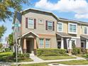 Inviting townhome with lush landscaping and a corner street sign at 7776 Rigby St, Windermere, FL 34786
