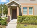 A close-up of the home's entrance with manicured landscaping at 7776 Rigby St, Windermere, FL 34786