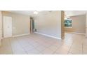 Spacious living area with tile flooring, ceiling fans, and neutral paint at 913 Jacaranda Dr, Lady Lake, FL 32159