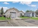 Single-story home featuring an attached garage and a well-maintained lawn under a blue sky at 1525 Rivers Edge Dr, Orlando, FL 32825