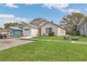 A charming single-story home featuring an attached garage and a lush green lawn at 1525 Rivers Edge Dr, Orlando, FL 32825