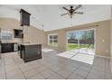 Bright eat-in kitchen featuring tile floors, granite countertops, and stainless steel appliances at 2421 Hybrid Dr, Kissimmee, FL 34758