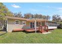 Home exterior showcasing a backyard patio, enclosed porch, and a green lawn, perfect for outdoor enjoyment at 323 Marjorie Blvd, Longwood, FL 32750