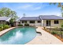 Backyard view with a pool, patio area, and a well-maintained lawn at 3553 Jericho Dr, Casselberry, FL 32707