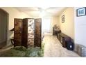 Neutral bedroom with a decorative folding screen, tile floors, and natural light from a window at 3810 Blue Dasher Dr, Kissimmee, FL 34744