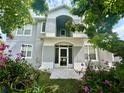 Inviting two-story home featuring a tiled entry, decorative plants and flowers, and a welcoming facade at 3810 Blue Dasher Dr, Kissimmee, FL 34744