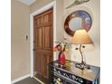 Inviting entryway showcasing a stylish table, decorative mirror, and elegant floral accents at 4200 Lake Underhill Rd # 2B1, Orlando, FL 32803