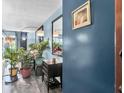 Stylish blue living room featuring modern decor, plants and a large mirror at 4200 Lake Underhill Rd # 2B1, Orlando, FL 32803