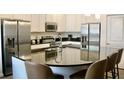 Kitchen with stainless steel appliances, a modern countertop, and seating at 4489 Monado Dr, Kissimmee, FL 34746