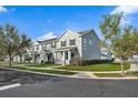 Neighborhood street showing several townhomes with well-maintained lawns and landscaping at 502 Rainbow Springs Loop, Groveland, FL 34736