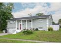 Charming home with an attached garage, well-manicured front yard and a bright red door at 504 Teakwood Dr, Altamonte Springs, FL 32714