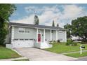 Two-story home featuring an attached garage, well-maintained lawn, and a bright red front door at 504 Teakwood Dr, Altamonte Springs, FL 32714