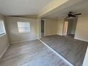 Open living room featuring new wood floors, neutral paint, and abundant natural light at 508 W Crescent Dr, Lakeland, FL 33805