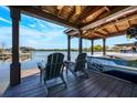 Picturesque boat dock featuring an open-air covered structure, seating, and a watercraft at 5101 The Oaks Cir, Orlando, FL 32809