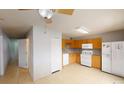 Functional kitchen with wooden cabinets, white appliances and tile flooring at 5132 Luna Negra Dr, Orlando, FL 32811