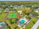 Community aerial view showcasing the pool, tennis courts, playground, and lush greenery at 527 Durango Loop St, Davenport, FL 33897