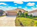 Inviting single-Gathering home featuring a well-manicured lawn and a two-car garage at 527 Durango Loop St, Davenport, FL 33897