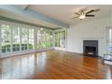 Bright living room with hardwood floors, fireplace, and lots of windows to the front yard at 719 S Summerlin Ave, Orlando, FL 32801