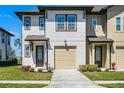 Inviting two-story home with a single-car garage, featuring a well-manicured lawn and a cozy entryway at 824 Longboat Dr, Davenport, FL 33896