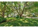 Lovely home with mature trees, green lawn, and charming curb appeal at 2930 Westgate Dr, Eustis, FL 32726