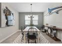 Well-lit dining room with modern decor, designer rug and stylish lighting fixture at 10509 Authors Way, Orlando, FL 32832