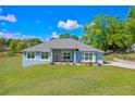 Attractive one-story home showcasing a lush green lawn and a welcoming facade at 10544 Parkway Dr, Clermont, FL 34711